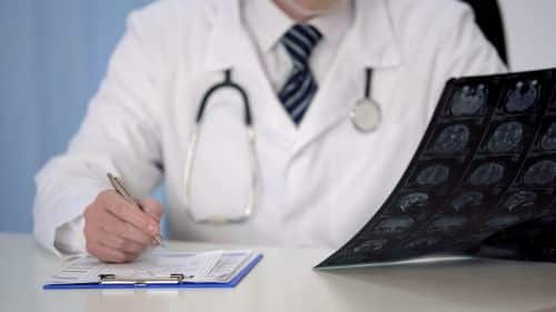 A doctor reviewing traumatic brain injuries.